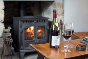red wine in front of fire